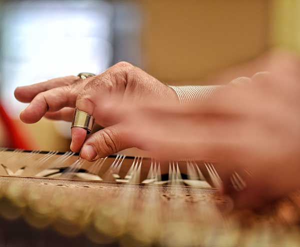 musician-playing-an-arabic-qunon-dulcimer