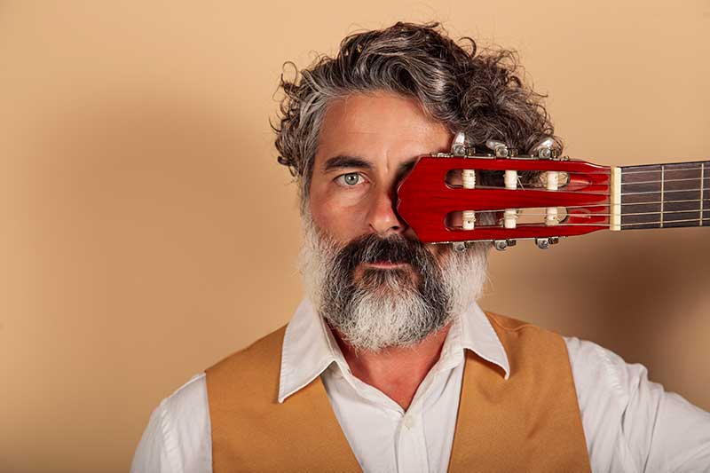 closeup-portrait-of-a-bearded-man-with-spanish-guitar