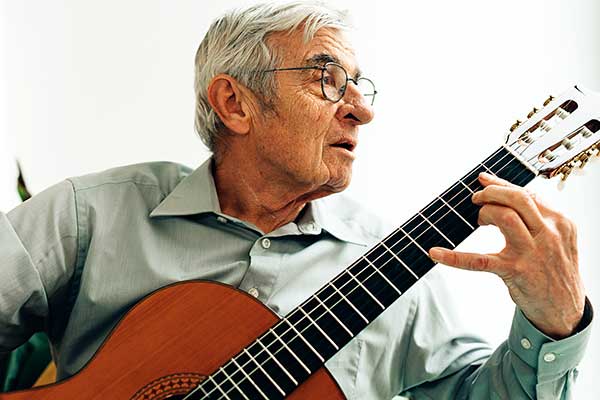 elderly-man-playing-on-acoustic-guitar