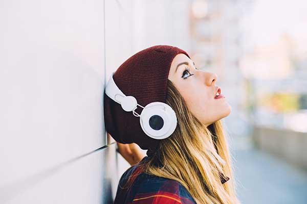 young-woman-outdoor-listening-music